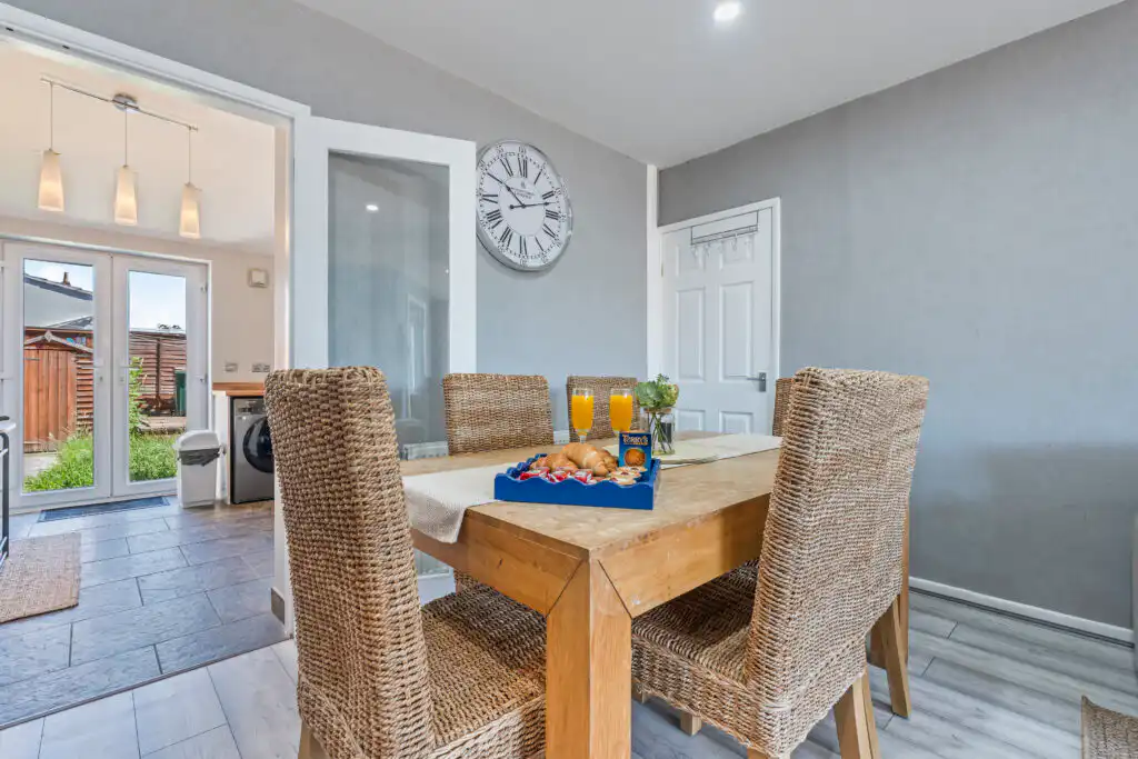 Modern dining room with wooden table and breakfast setup