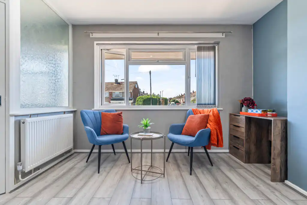 Cozy seating area with blue chairs by window