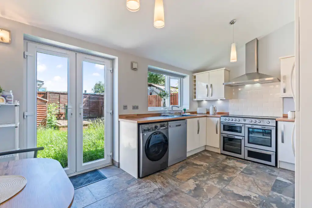 Bright modern kitchen with patio doors and garden view