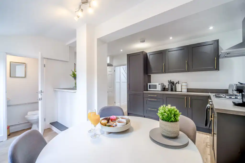 Modern kitchen with gray cabinets and dining table