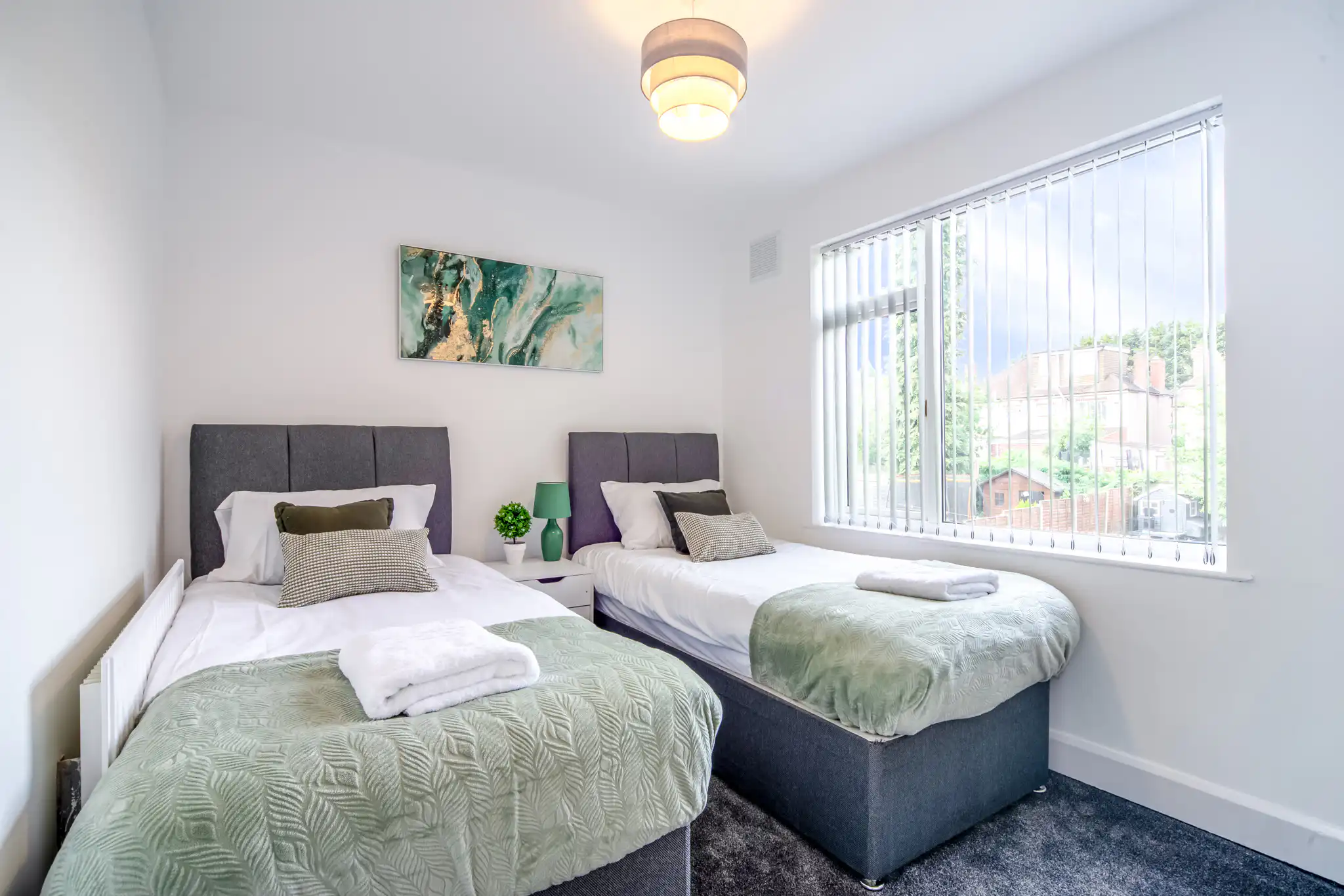 Bright bedroom with two twin beds and window